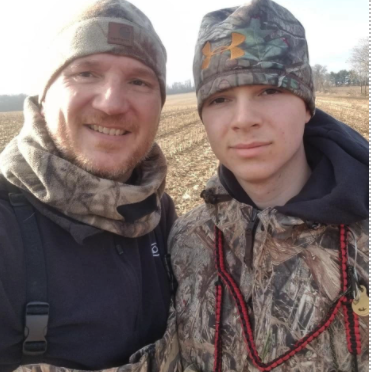 two men dressed in camo hunting gear